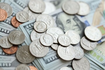 Many hundred dollar bills and US cents coins. Different coins and banknotes.