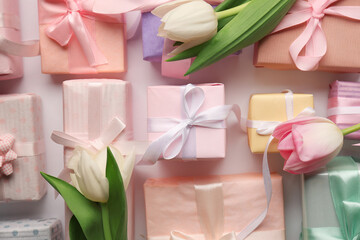 Gift boxes with tulips on white background. Happy Women's Day