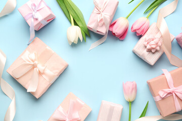 Frame made of gift boxes with tulips on blue background. Happy Women's Day