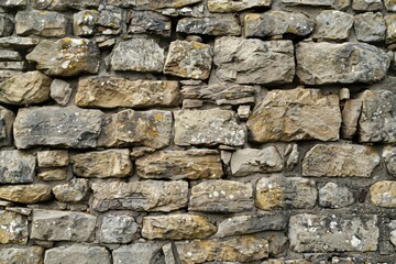 Obraz premium Image of Old grey and brown stone wall. Texture for background usage