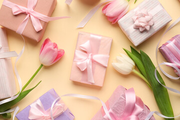 Gift boxes with tulips on beige background. Happy Women's Day