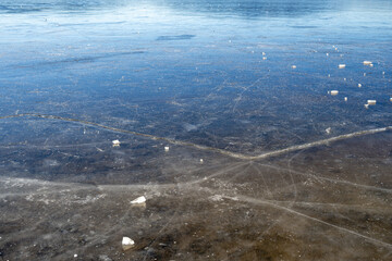 Winter sunny day at a frozen lake with ice floes