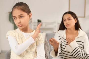 Offended girl and her apologetic mother at home