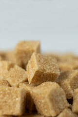 Macro cubes of brown cane unrefined demerara sugar.