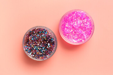 Jars of glitter on pink background