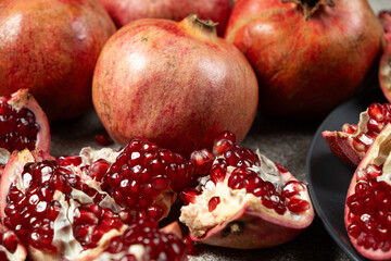 Ripe pomegranates, peeled and whole, the concept of benefits and vitamins in fruit.