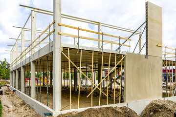 Unfinished new modern reinforced concrete and metal structure building frame