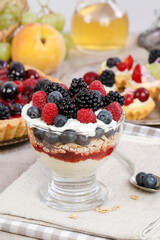 Layer fruit dessert in glass container. Summer party.