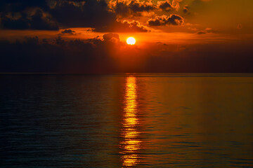 Sunset with reflected rays over the vast ocean