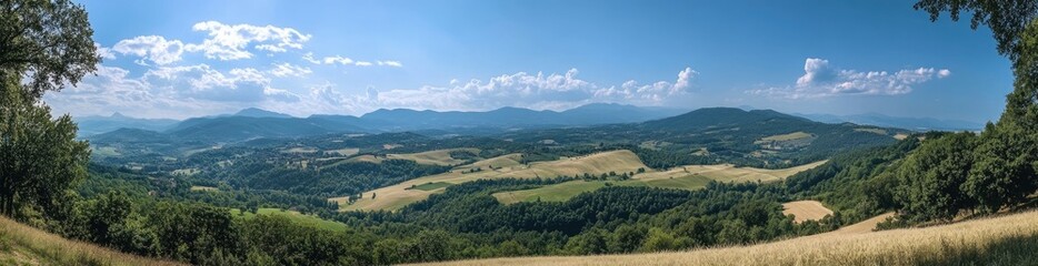 Fototapeta premium Panoramic shot of an idyllic French countryside, with rolling hills and wheat fields