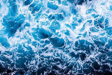 Ocean water background. Top view of captivating foamy water. Can be used in covers, packaging, posters, textures, cards, art and design projects. Amazing nature background image.