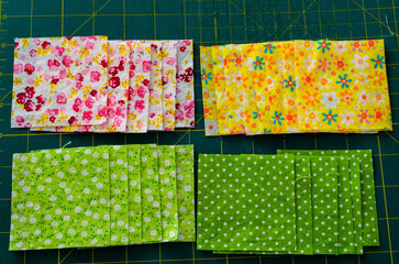 Fototapeta premium Above view of layered fabric squares for a quilt