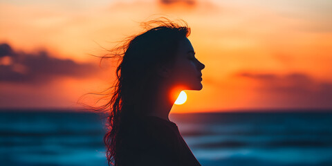 Profile of a Woman's Silhouette Against Ocean Sunset