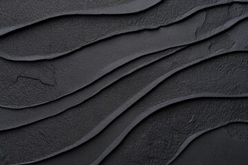 Fototapeta premium 黒いテクスチャーが織りなす波状のデザインが印象的な背景