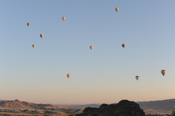 Hot air balloons flying over blue sky on a sunny morning in Cappadocia, Turkey