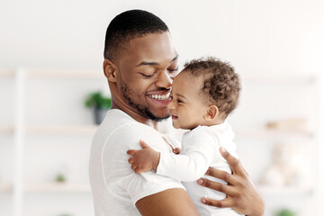 Portrait Of Young Black Father And Infant Child Bonding Together At Home, Loving African American...