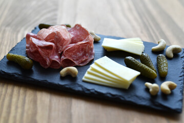 Aperitif board with cheese salami and gherkins