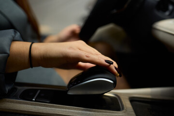 An Elegant Hand Gracefully Resting on the Luxury Car Gear Shift of a Modern Vehicle