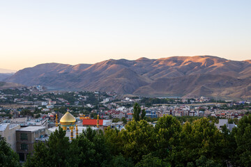 sun rise over a valley and village with mountains in the background houses and trees with clear skies in lavasoon iran tehran
