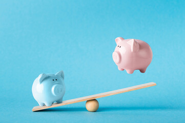 Savings concept. Comparison of two variants of investing money with piggy banks on blue background,...