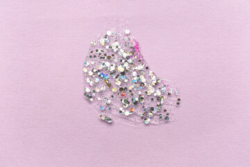 Silver glitter stroke on lilac background, closeup