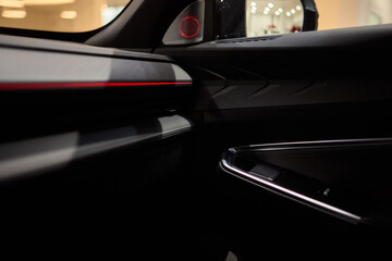 Stylish and Modern Car Interior Design Featuring Carbon Fiber Accents and Ambient Lighting