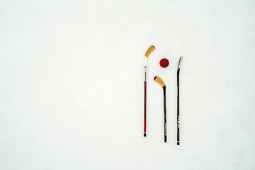 Puck and ice hockey stick against a scratched surface featuring an abstract backdrop in an ice arena