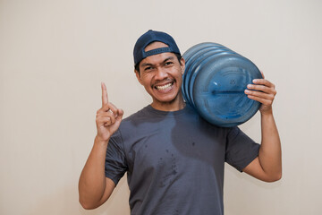 Smiling Southeast Asian man wear blue cap and green t-shirt work as dealer courier hold big large...