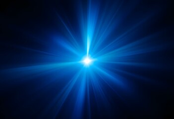 Bright blue light burst with radial rays on dark background. Glowing star effect with lens flare. Abstract cosmic energy background for spiritual, space and science designs