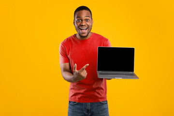 Great Website. Excited African American Man Showing Laptop Computer Blank Screen To Camera Posing...