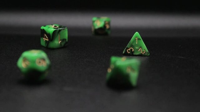 D20, D12, D9, D90, D8, D6, D4, Green dice rolled on a black background. Close-up slowmotion high quality video 