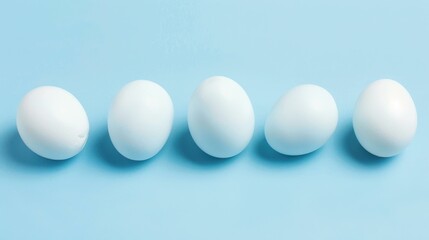 A vibrant row of dyed Easter eggs in soft pastel blue, perfect for spring celebrations and festive traditions.