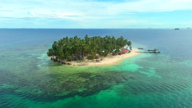 Aerial view of a beautiful tropical island with palm forest and dock in the Caribbean Sea. San Blas Islands In Panama. drone shot