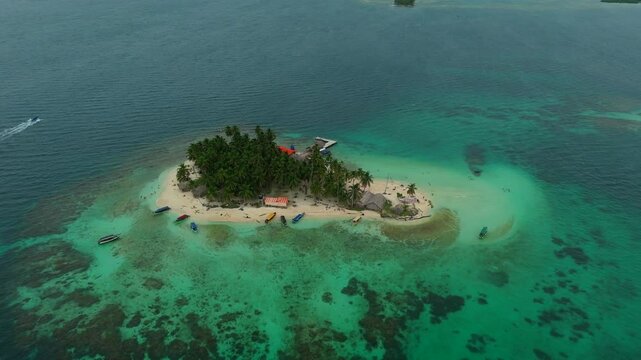 Aerial view of a beautiful tropical island with palm forest and dock in the Caribbean Sea. San Blas Islands In Panama. drone shot