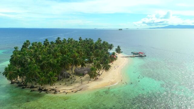 Aerial view of a beautiful tropical island with palm forest and dock in the Caribbean Sea. San Blas Islands In Panama. drone shot