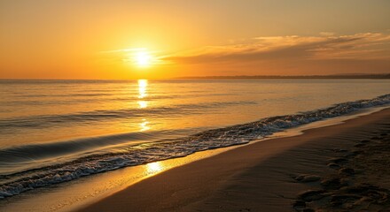 A serene beach scene with footprints in the sand leading to the calm waves