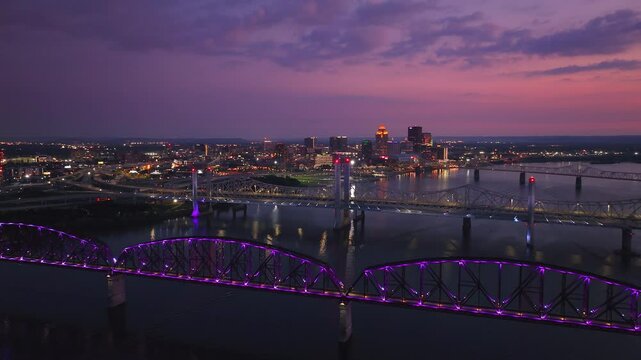 Radiant Nights: Purple-Lit Bridges Over the Ohio River in Louisville, Kentucky