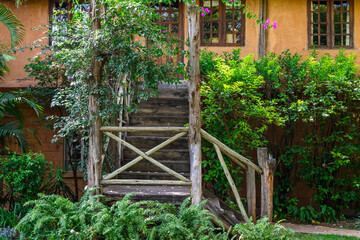 Luxury resort experience, at traditional African game lodge, tropical garden and rustic wood staircase, Lewa Conservancy, Kenya, Africa
