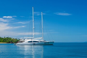 Large white boat is docked in the water