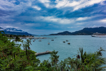 View of the Sao Sebastiao navigation channel in Sao Paulo, Brazil, with boats and ships on a cloudy day
