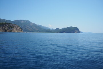 RT Dubovica Rocks near Buljarica and Svetac Rock, Montenegro. Stones, inaccessible rocks. Flysch marine lithological layers. Adriatic Mediterranean sea blue water. Nature park Katici. District Budva