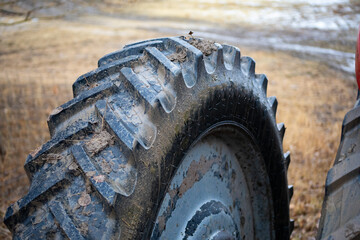 Wheel of the tractor covered in mud