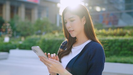 Confident woman Using Smartphone in Modern Cityscape. woman using mobile phone. Reading news, chatting on mobile application. Woman texting on phone. artificial intelligence Ai chatbot