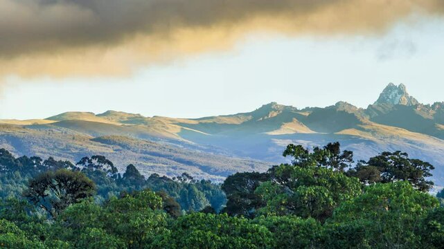 Panning shot of Mount Kenya and surrounding rain forest, early morning with golden light, shot in 4k.
