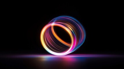 Colorful light trails forming glowing rings on dark background.