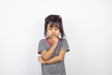 Portrait of little Asian girl posing on white background