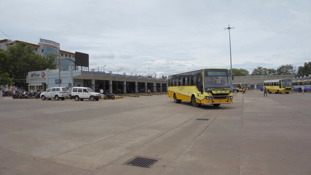 View of Christopher Bus Stand in Vadasery, Nagercoil with buses and people on cloudy day. Spacious and clean bus stand