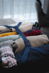 Obraz premium Neatly Packed Clothes in a Suitcase for Travel Convenience
