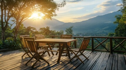 Fototapeta premium A serene wooden deck with chairs overlooking a mountain landscape at sunset.