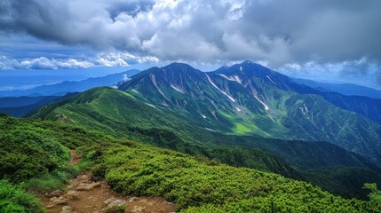 Fototapeta premium The Ushiro-Tateyama range under dramatic storm clouds, with Mt. Shirouma partially illuminated by a break in the weather